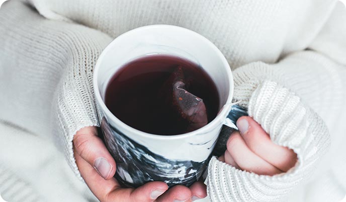 Woman holding herbal tea